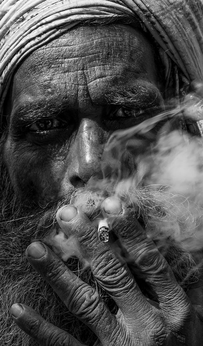 Mastering the First Impression: Your intriguing post title goes here A powerful black and white close-up portrait of an elderly man smoking, showcasing wrinkles and texture.